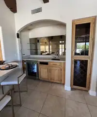 Before: Dated arch to a lit marble bar.